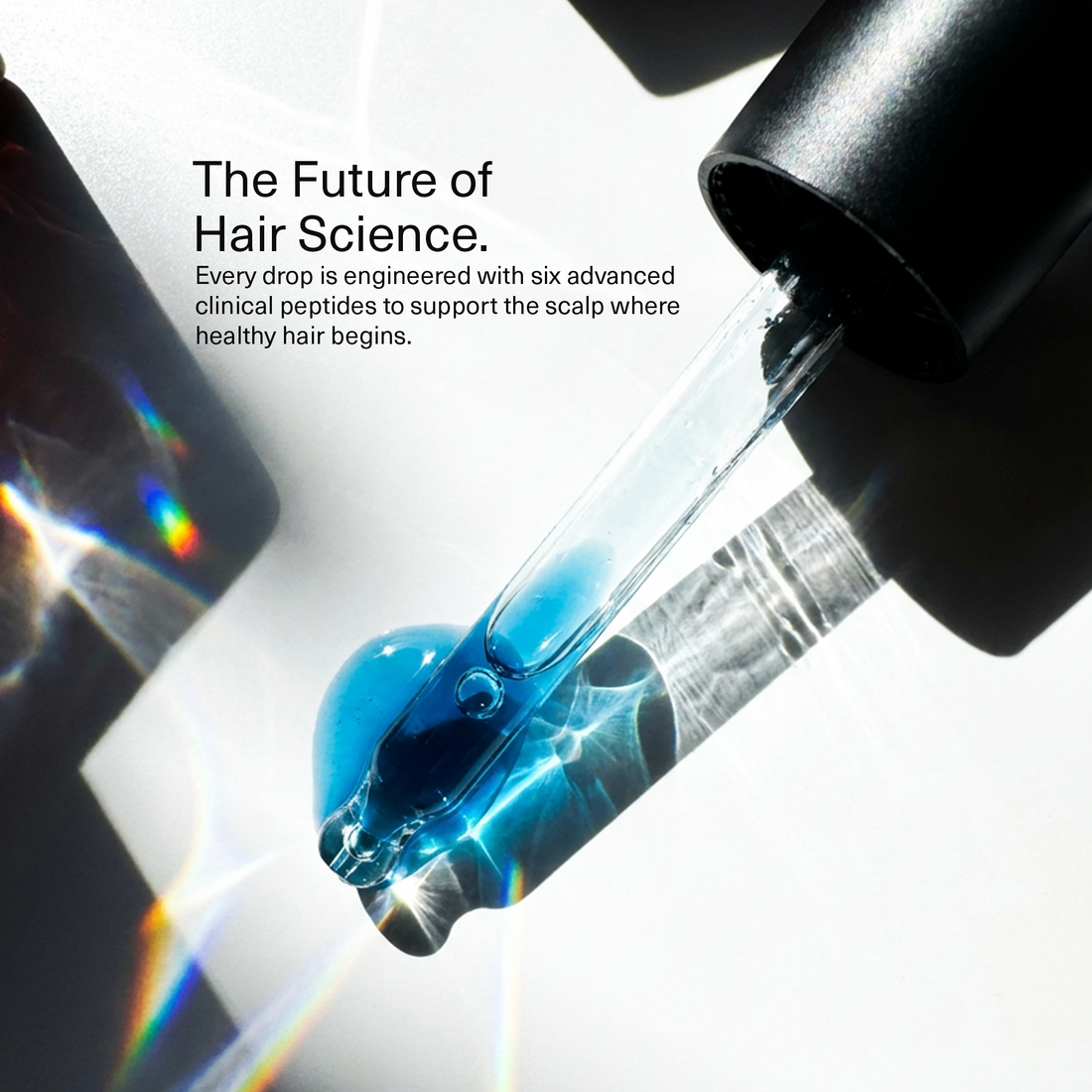The future of hair science: a glass pipette releasing Bloom's blue serum, made with six clinical peptides to support the scalp where healthy hair begins